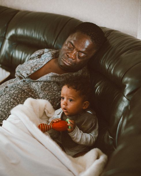 juneteenth clockingyou father sleeping on couch with baby humphrey-muleba unsplash