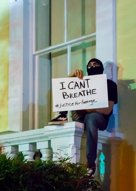 juneteenth clockingyou man holding I can't breathe sign outside window gayatri-malhotra-unsplash