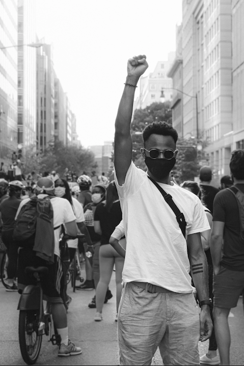 juneteenth clockingyou man holding fist high in protest gayatri-malhotra-unsplash