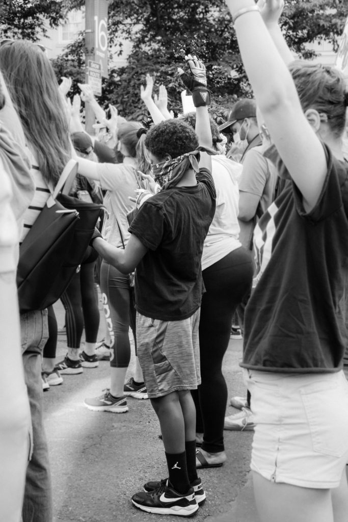 juneteenth clockingyou child with raised hand with other kids protesting gayatri-malhotra unsplash