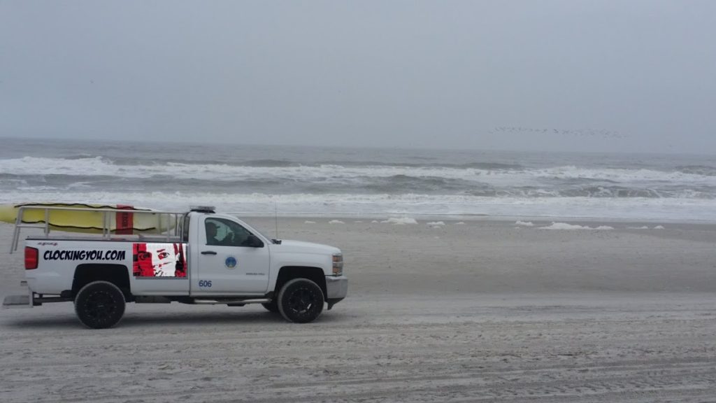 red-clockingyou-mask-logo-on-truck-beach