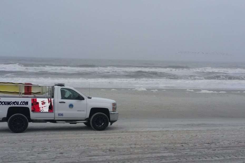 red-clockingyou-mask-logo-on-truck-beach
